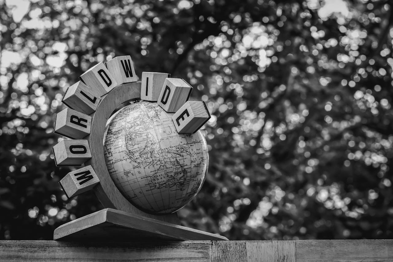 Vintage-style black and white photo of a globe with worldwide text.